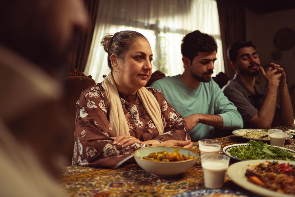 a family gathered around a dining table sharing a meal