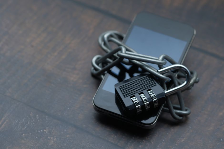 smartphone wrapped in chain with padlock