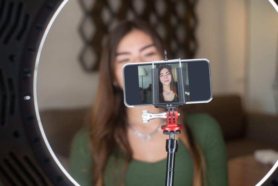 a young woman recording a video on her phone