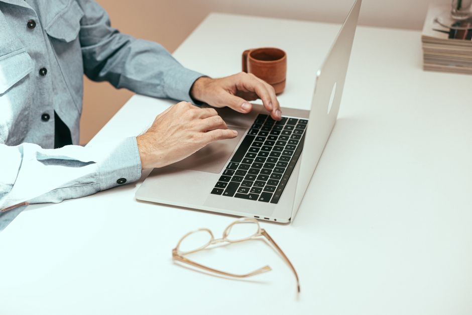 person typing on laptop keyboard