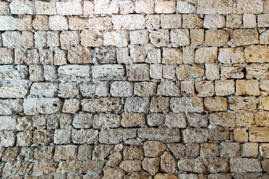 Close-up of an ancient stone wall with rich texture and history.