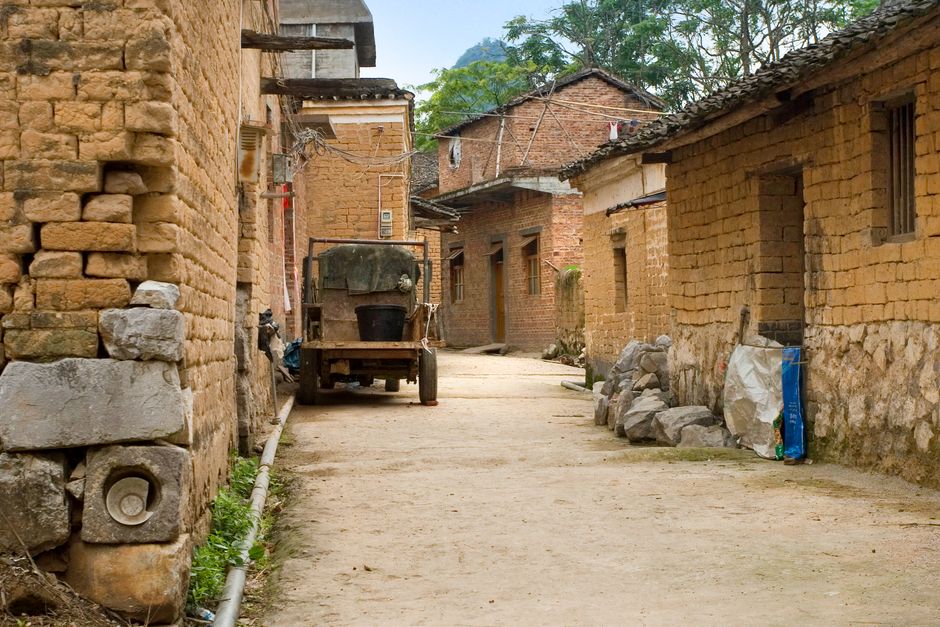 A quiet rural alley with traditional brick houses and rustic charm.