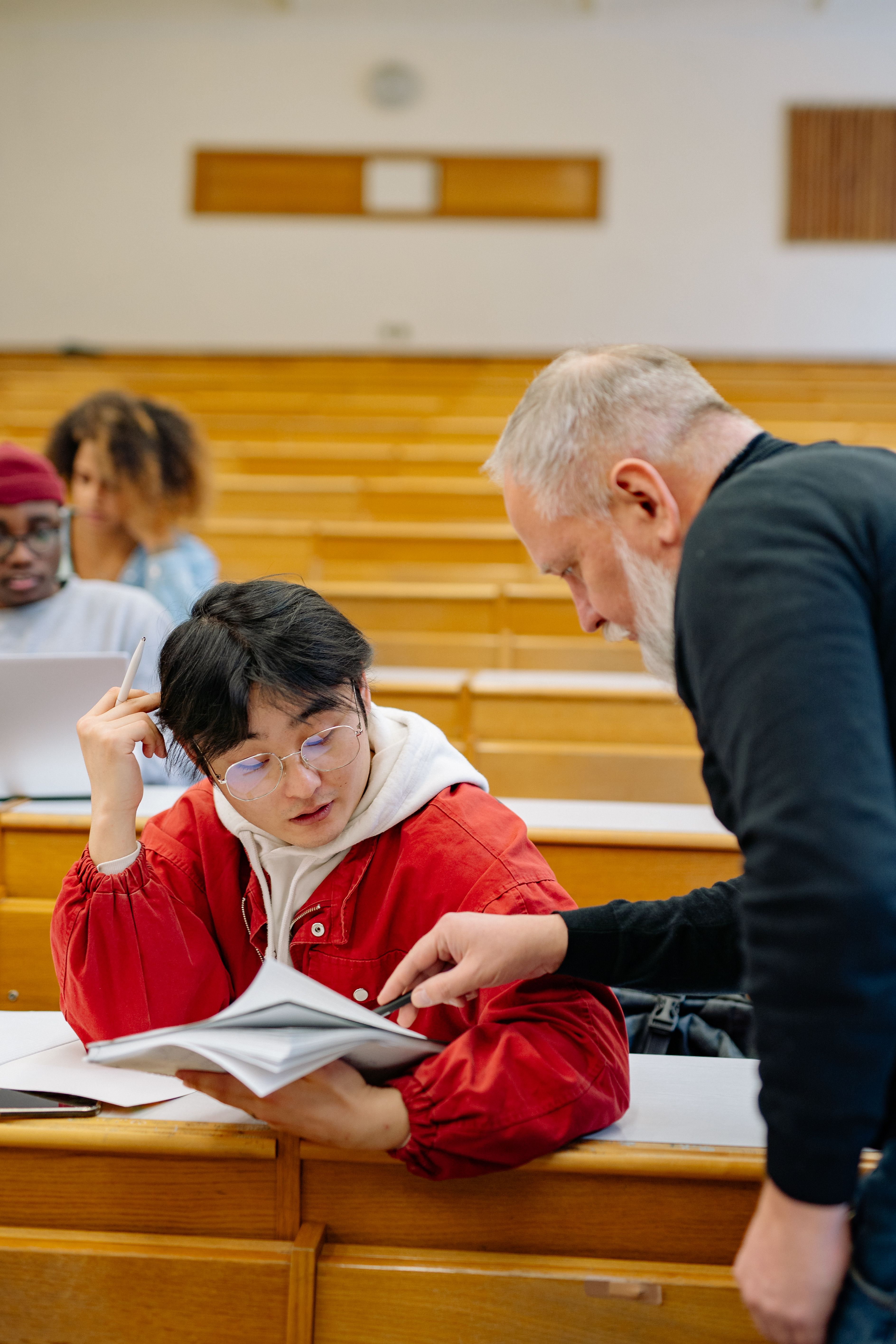 A professor helping a student overcome academic challenges through guidance and support.