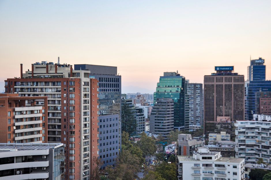View of Santiago's skyline featuring modern architecture during sunset.