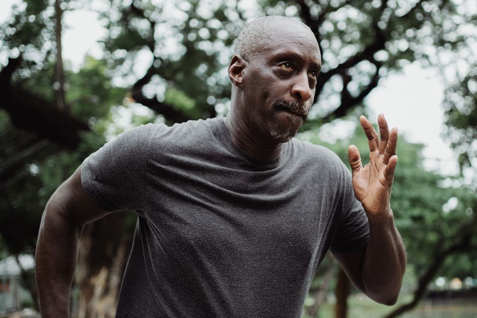 Focused mature man running to stay fit and maintain a healthy lifestyle outdoors.
