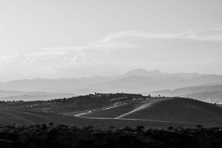 Black and white aerial view of Siirt's hills showcasing natural beauty and rural charm.
