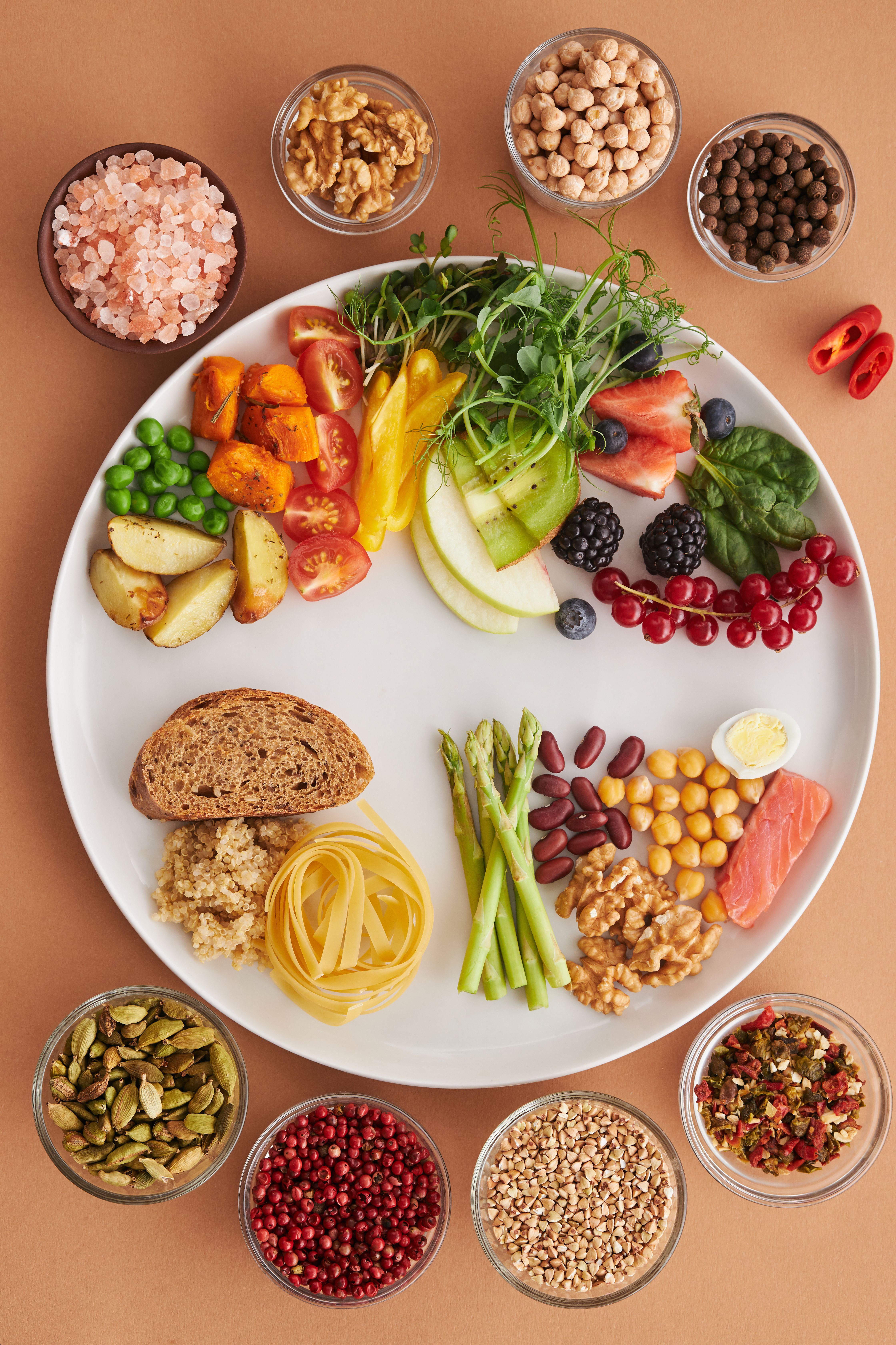 A flat lay of nutritious foods rich in iron, including legumes, vegetables, nuts, and other healthy ingredients that help support healthy iron levels and prevent iron deficiency.
