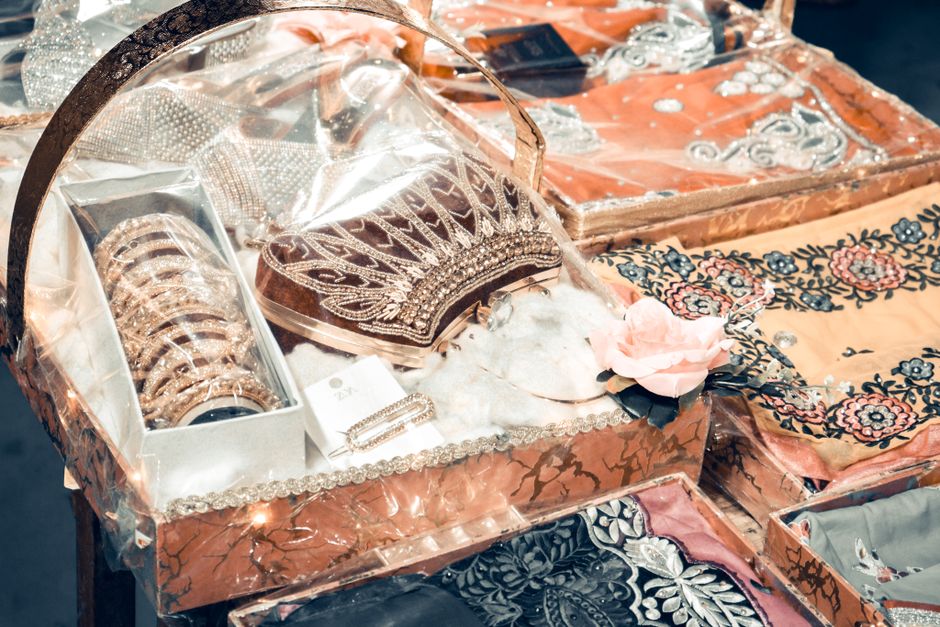 Intricate Indian wedding accessories including bangles and embroidered fabrics beautifully displayed for a traditional wedding.