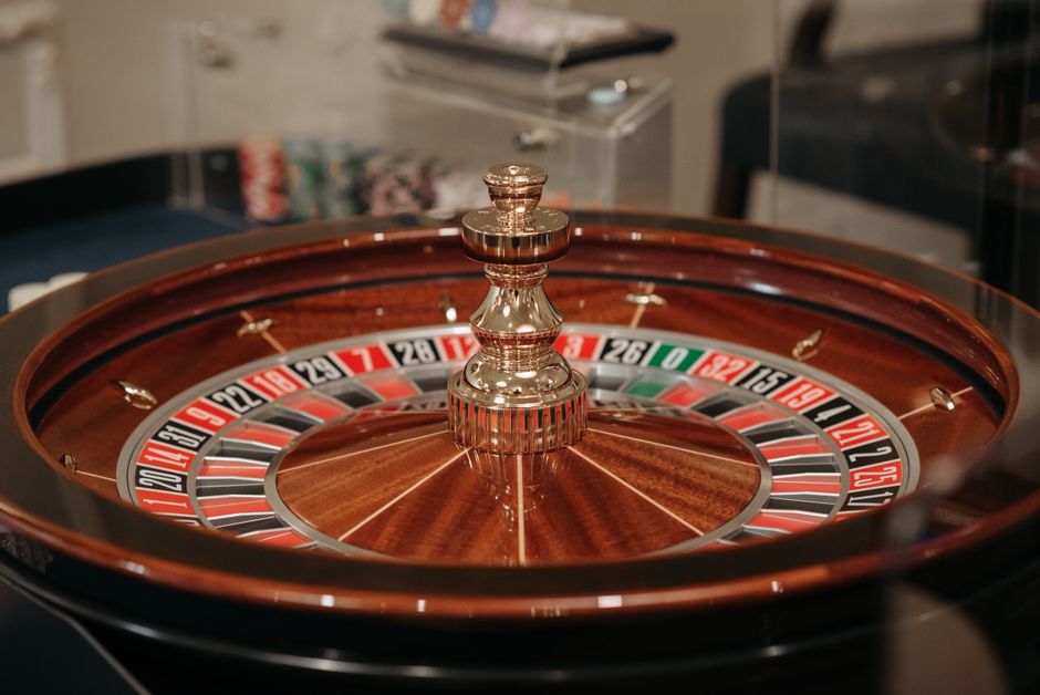 Close-up of a classic roulette wheel in a casino setting showcasing the elegant wooden design.