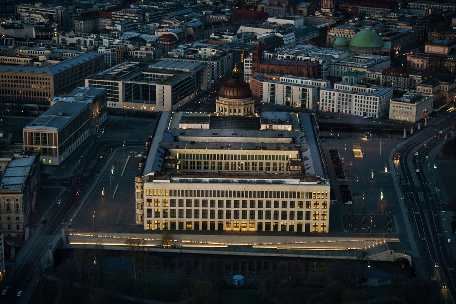 A stunning aerial shot of Berlin's cityscape featuring illuminated buildings and streets at night.