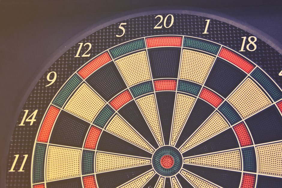Close-up of a dartboard displaying numbers and colored segments, perfect for themes of accuracy and games.