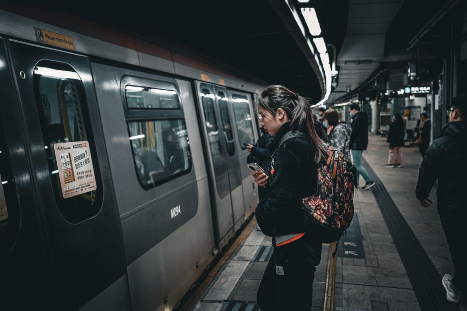 Commuters boarding a subway train at an underground station, showcasing public transit dynamics.
