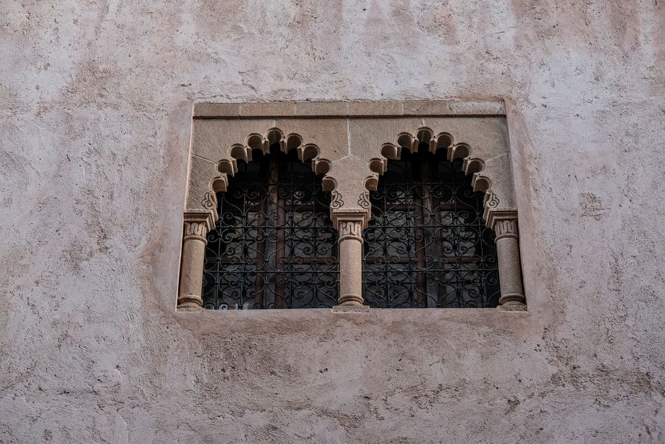 Stone wall window with ornamental arches in Rabat showcasing traditional Moroccan architecture.