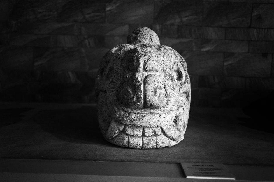 Black and white image of an ancient stone sculpture on display in Huaraz, Peru.