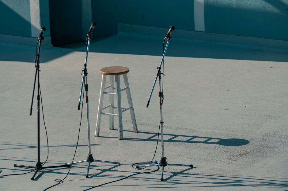 A serene outdoor stage setup featuring a bar stool and microphones in Vancouver, Canada.