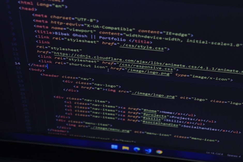 High-resolution close-up of HTML code displayed on a computer screen, perfect for technology themes.