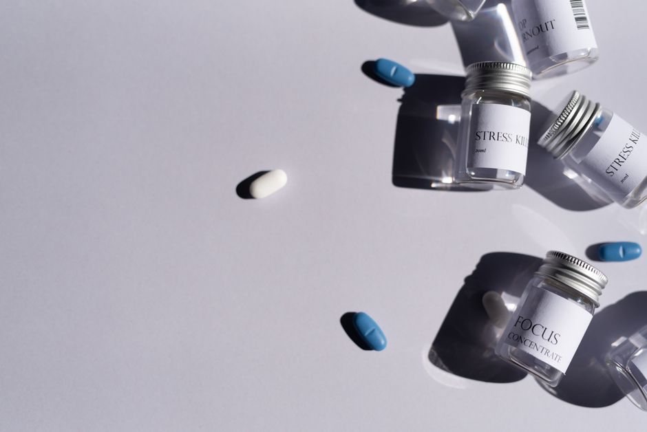 Flat lay of medicine bottles and pills on a white background, perfect for healthcare themes.