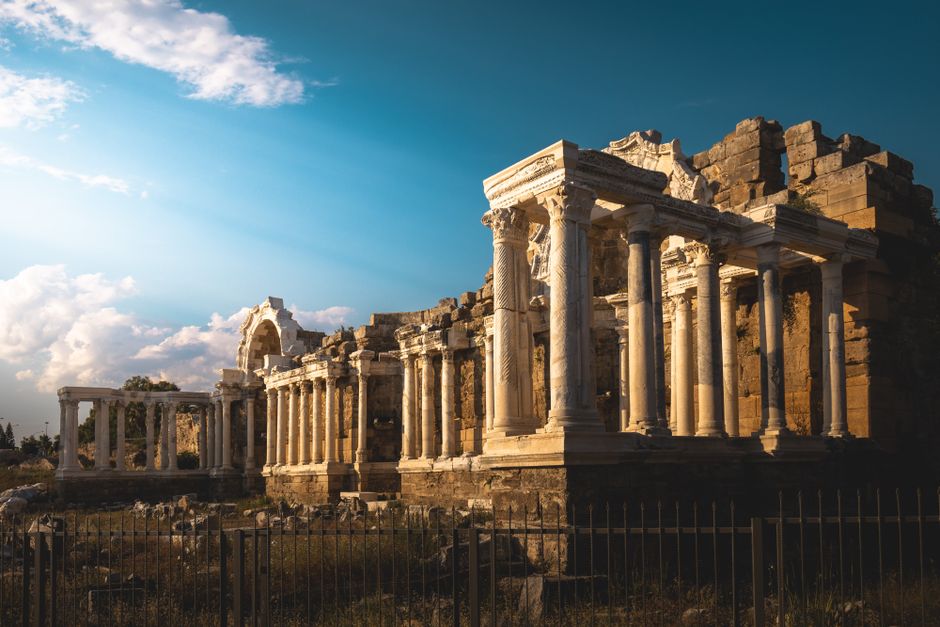 Stunning view of ancient Roman ruins at sunset showcasing classic architecture and historical allure.