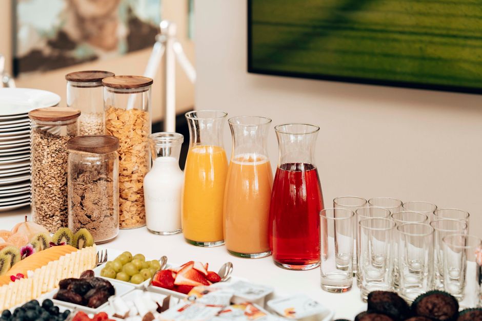 Streaming your daily routine An inviting breakfast buffet featuring juices, cereals, milk, fruits, and cutlery.