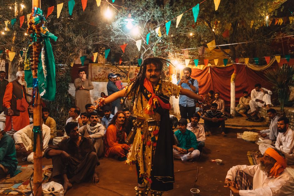 A lively celebration with traditional dancing and colorful decoration in Lahore, Pakistan during nighttime.