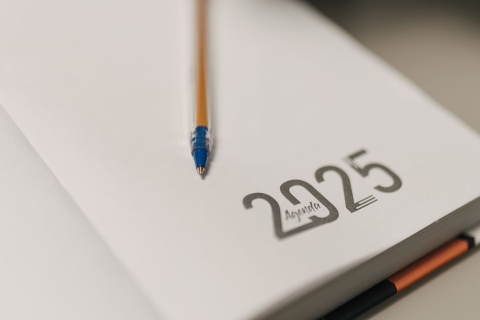 Closeup of a 2025 planner with a pencil, symbolizing planning and organization.