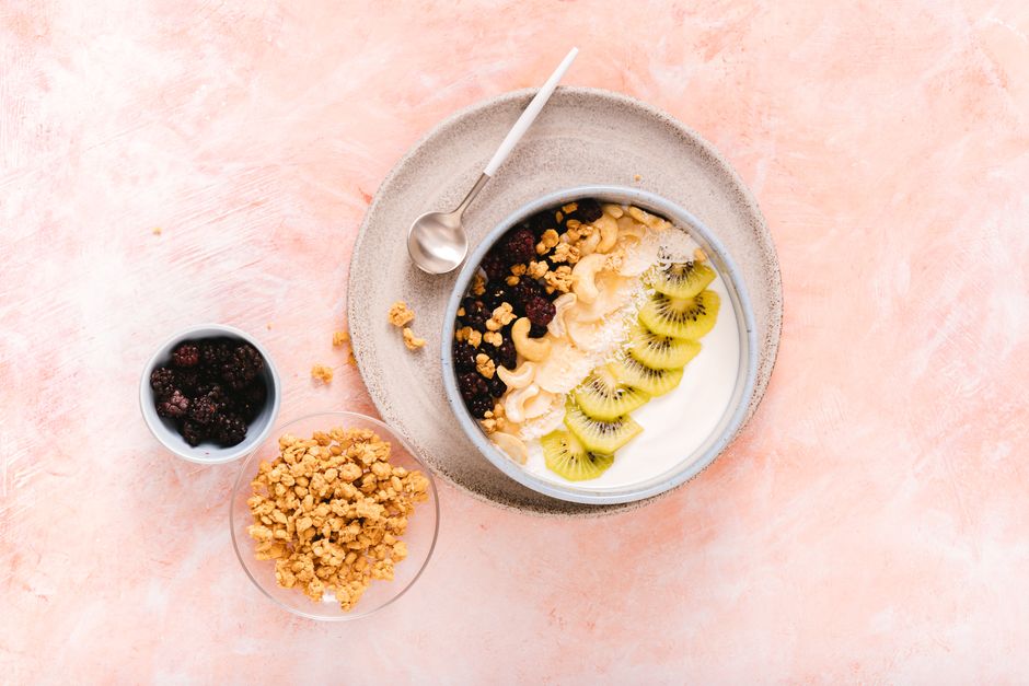 Delicious yogurt bowl topped with fresh kiwi, cashews, and mixed berries, perfect for a healthy breakfast.