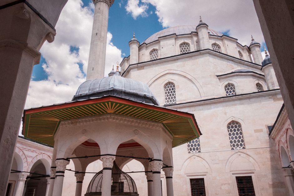A stunning view of an ancient Ottoman mosque's architecture in Bulgaria under a clear sky.