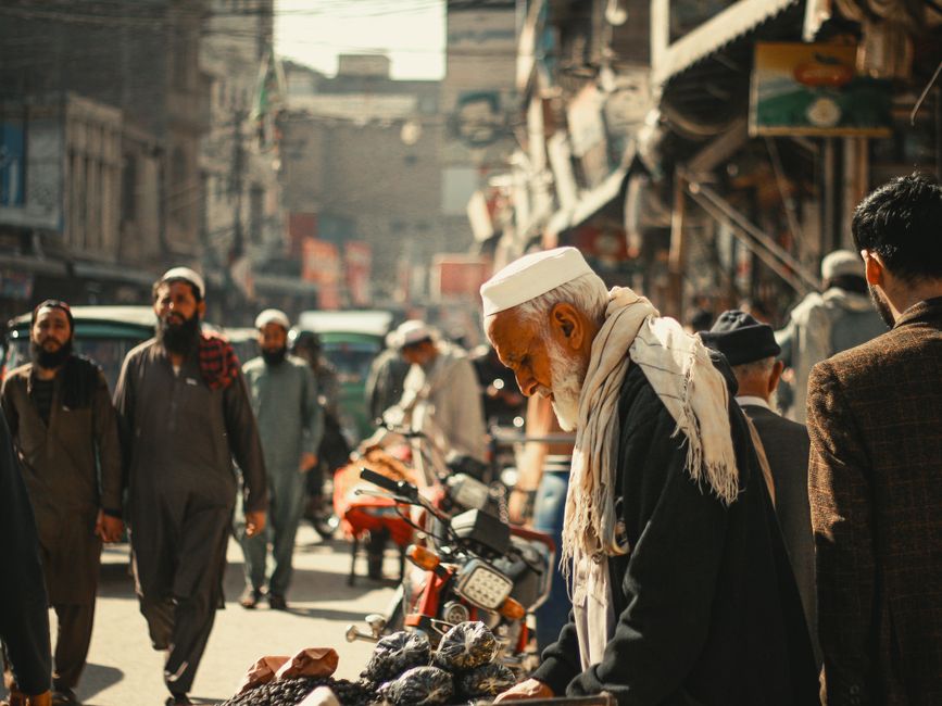 A vibrant street in Peshawar, Pakistan, featuring local culture, market hustle, and diverse individuals.