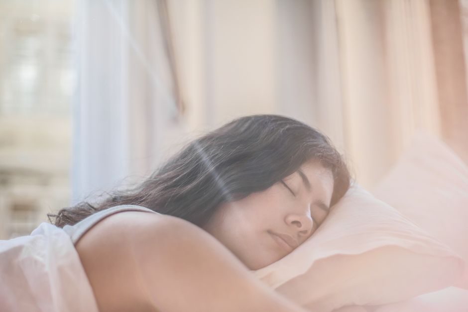 Sleep Portrait of a woman sleeping peacefully in soft morning light indoors.