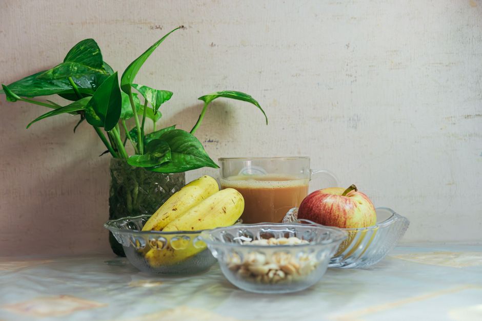 Refreshing breakfast arrangement with fruit, nuts, and tea for a healthy start.