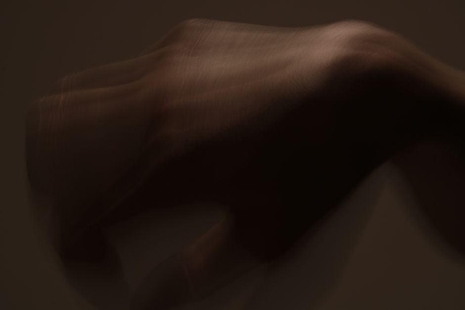 Surreal blurred motion image of a hand creating an abstract visual effect.
