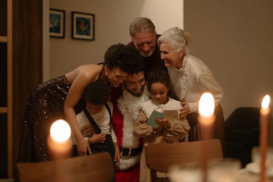 A joyful family gathers around Santa for a warm Christmas Eve celebration, sharing love and happiness.