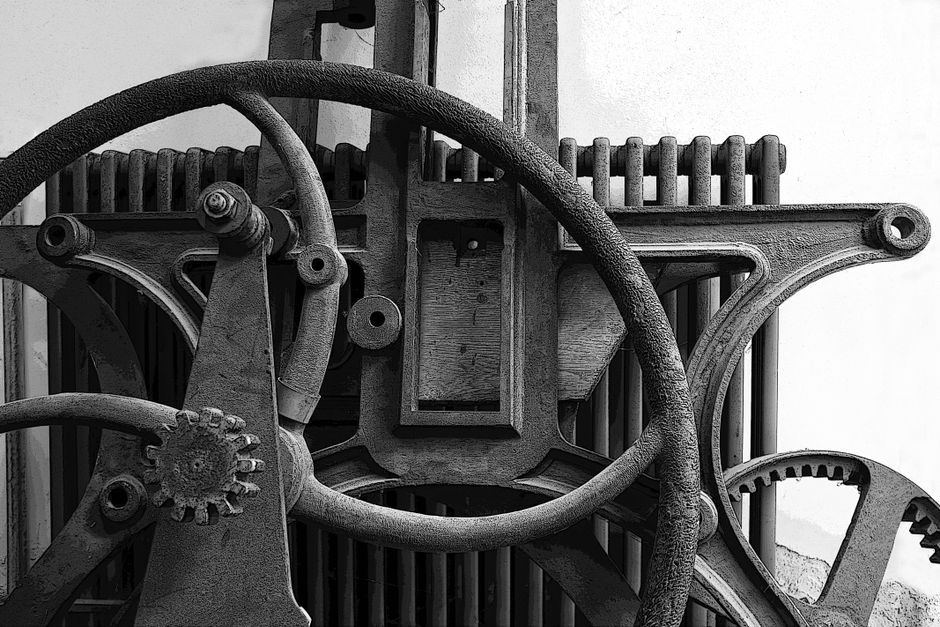 Close-up of vintage industrial machinery showcasing textured gears in a monochrome style.