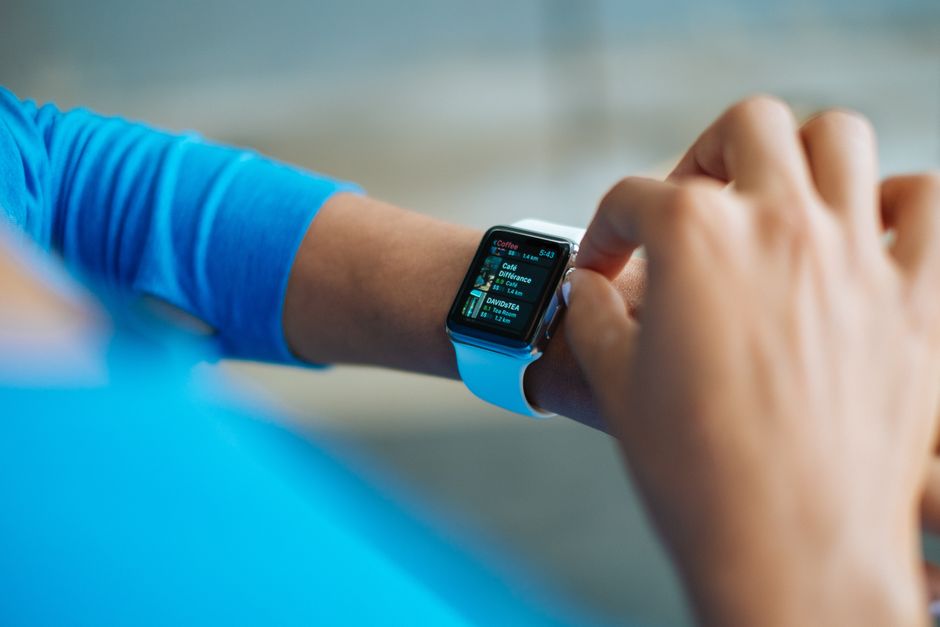 nanoparticle technology Person interacting with a smartwatch, showing a fitness application on the screen.