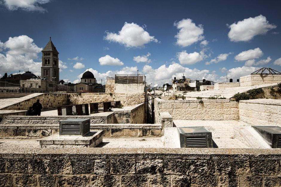Explore the blend of ancient stone architecture and vibrant skyline in Jerusalem on a sunny day.