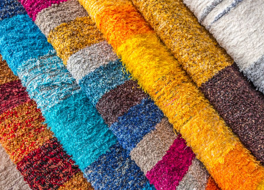 Vibrant close-up of assorted fabrics showcasing a variety of textures and patterns.